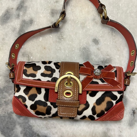 Coach Handbags - NWT vintage Y2K Coach Soho Leopard Baguette Bag with Red and Brown Accents.